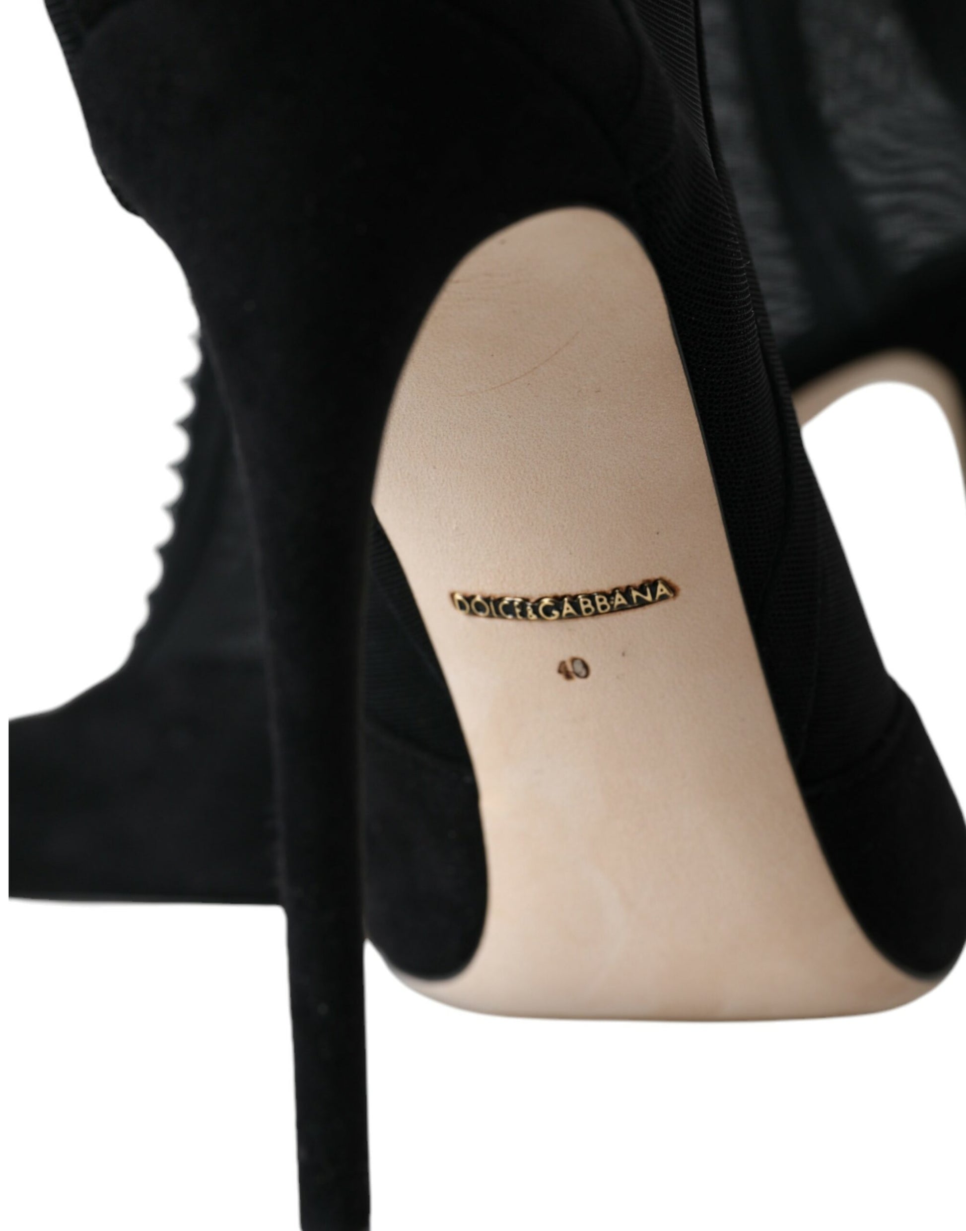 Black high heel shoe with gold logo on toe