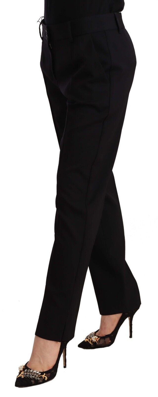 Woman wearing black pants and gold shoes