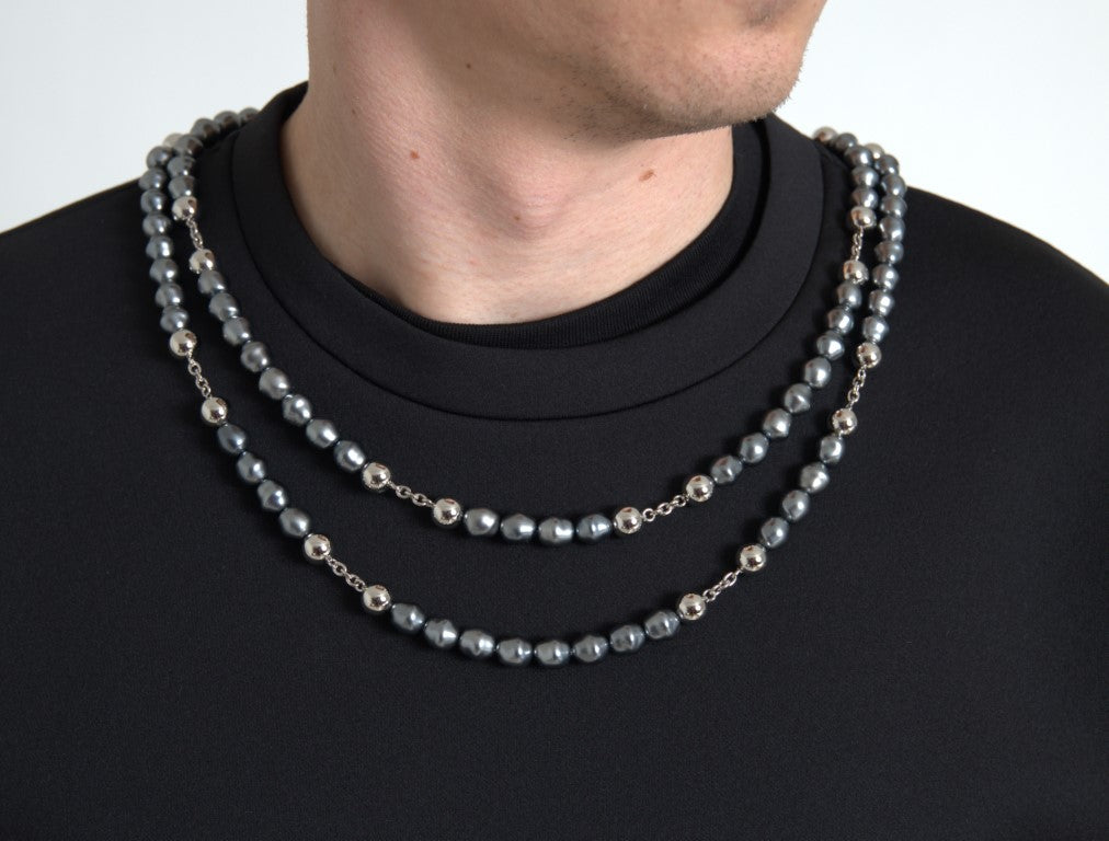 Man wearing necklace with multiple strands of beads