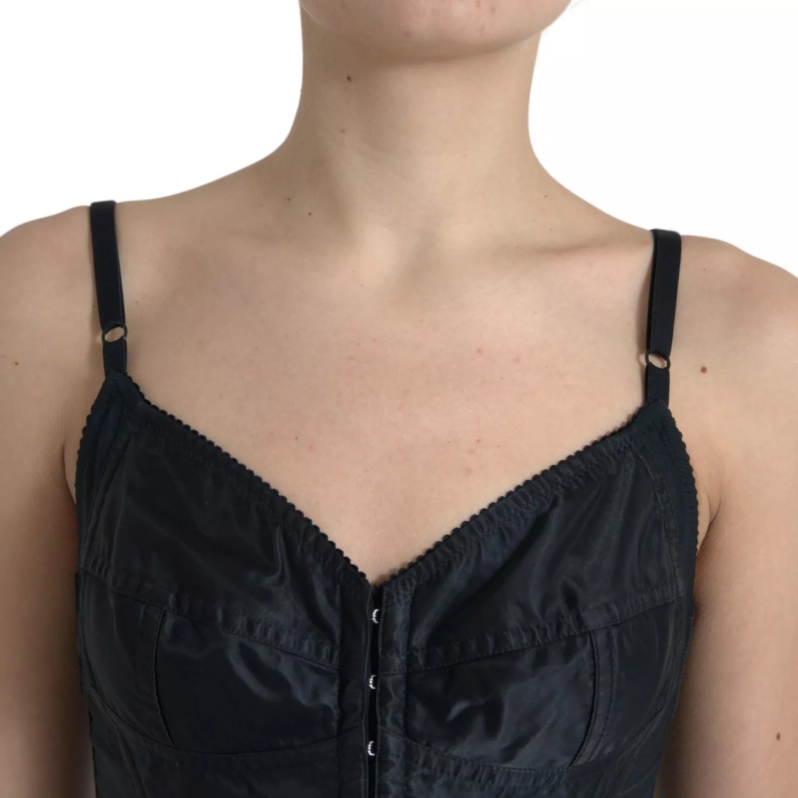 A black nylon bodycon corset bustier mini dress with a high neckline and zipper closure
