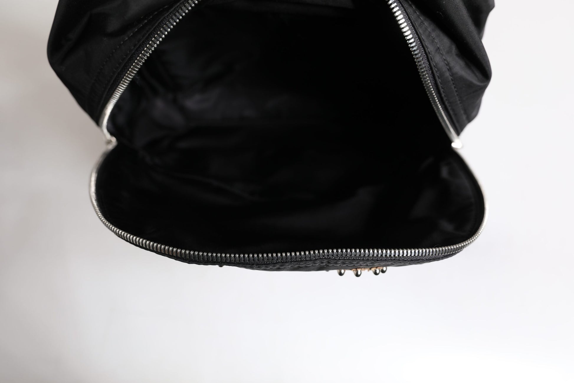 Black zippered jacket with a shiny silver zipper