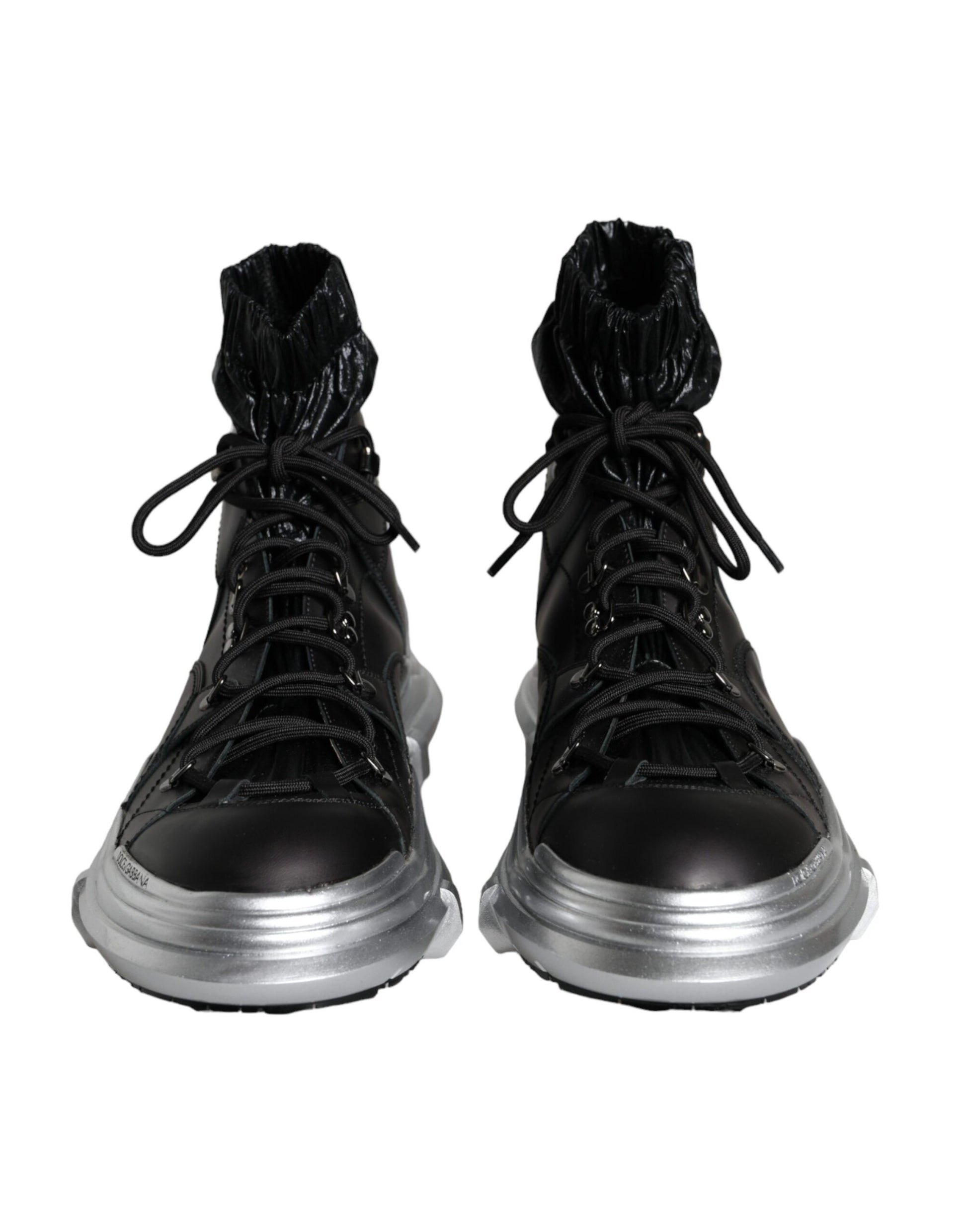 Pair of black boots with silver laces and soles