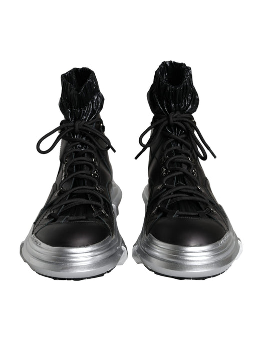 Pair of black boots with silver laces and soles