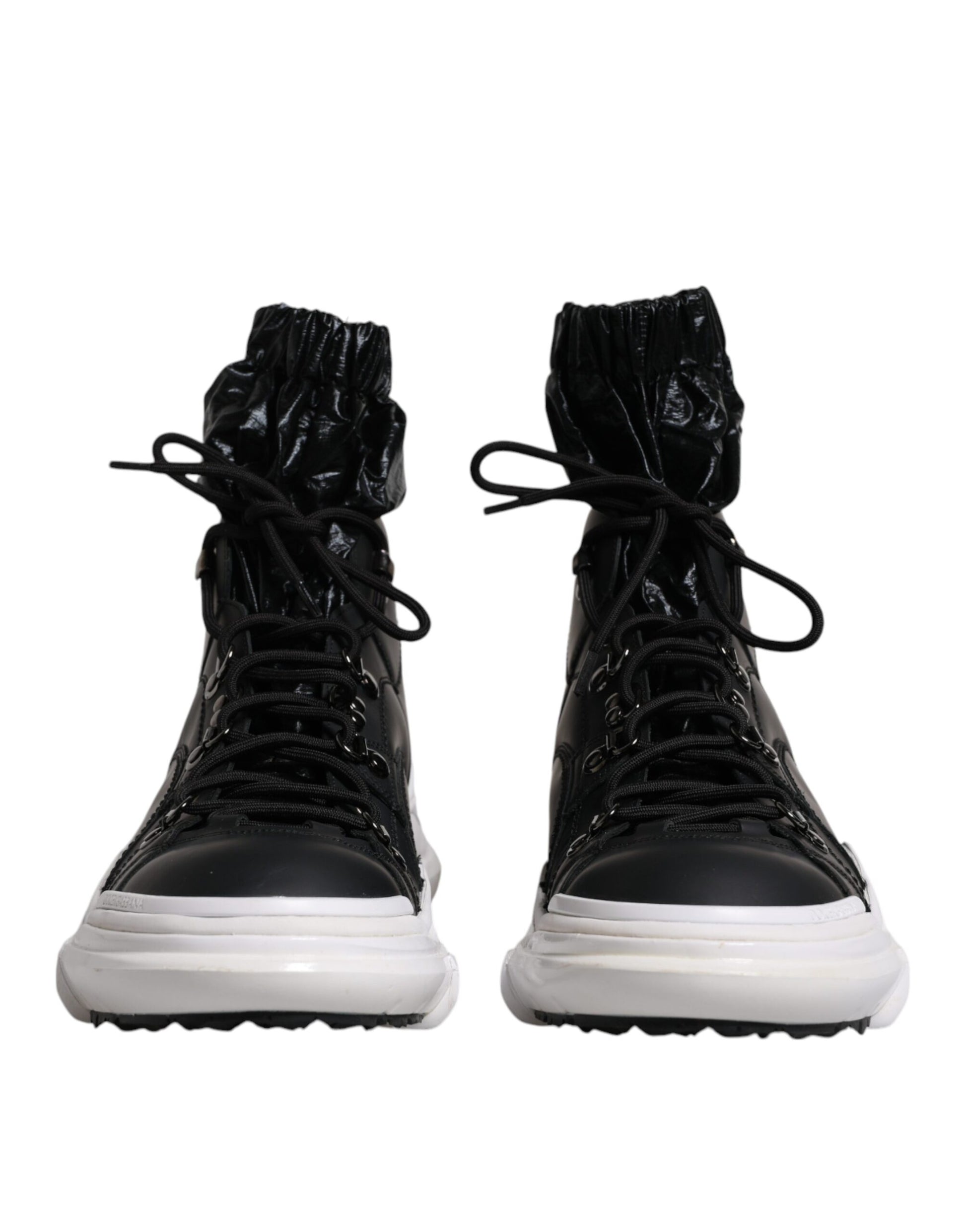 Pair of black boots with white soles and laces