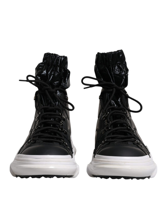 Pair of black boots with white soles and laces