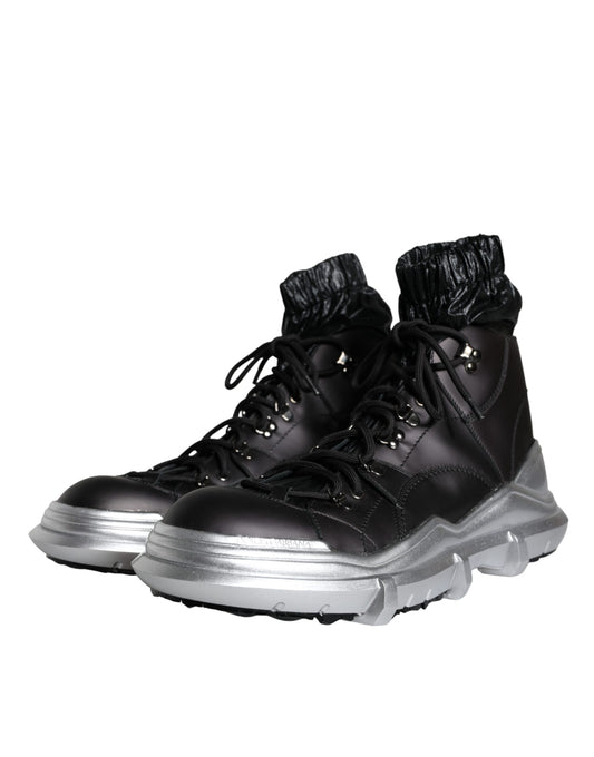Pair of black boots with silver accents and laces