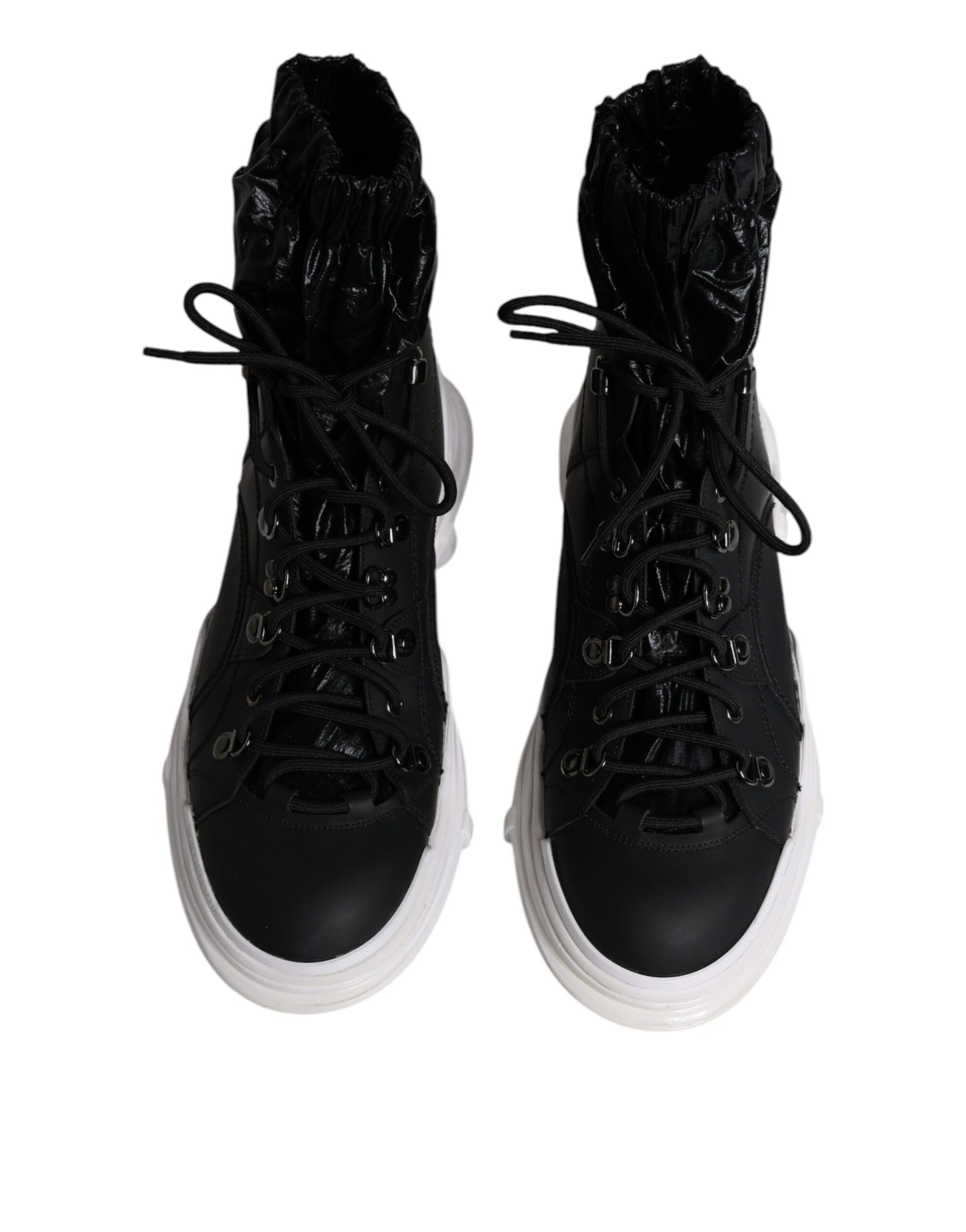 Pair of black boots with white soles and laces