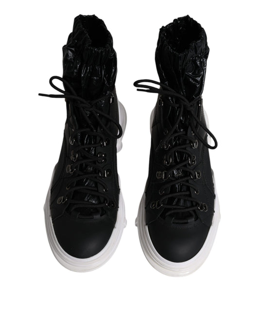 Pair of black boots with white soles and laces
