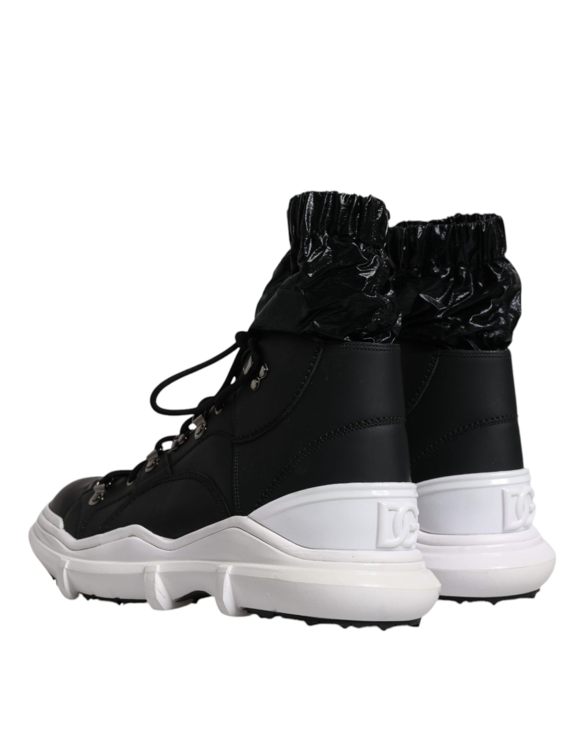Pair of black and white sneakers with laces tied at top