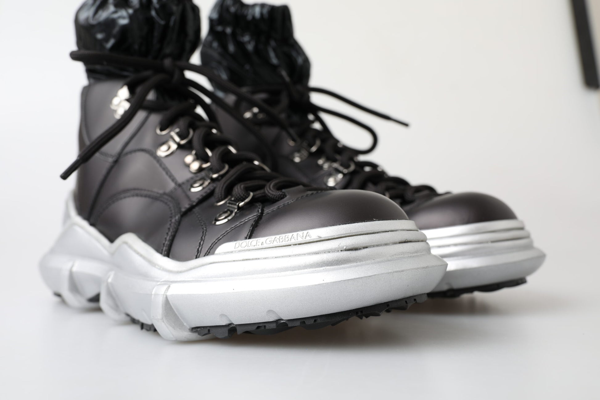 Pair of black and silver hiking boots with laces