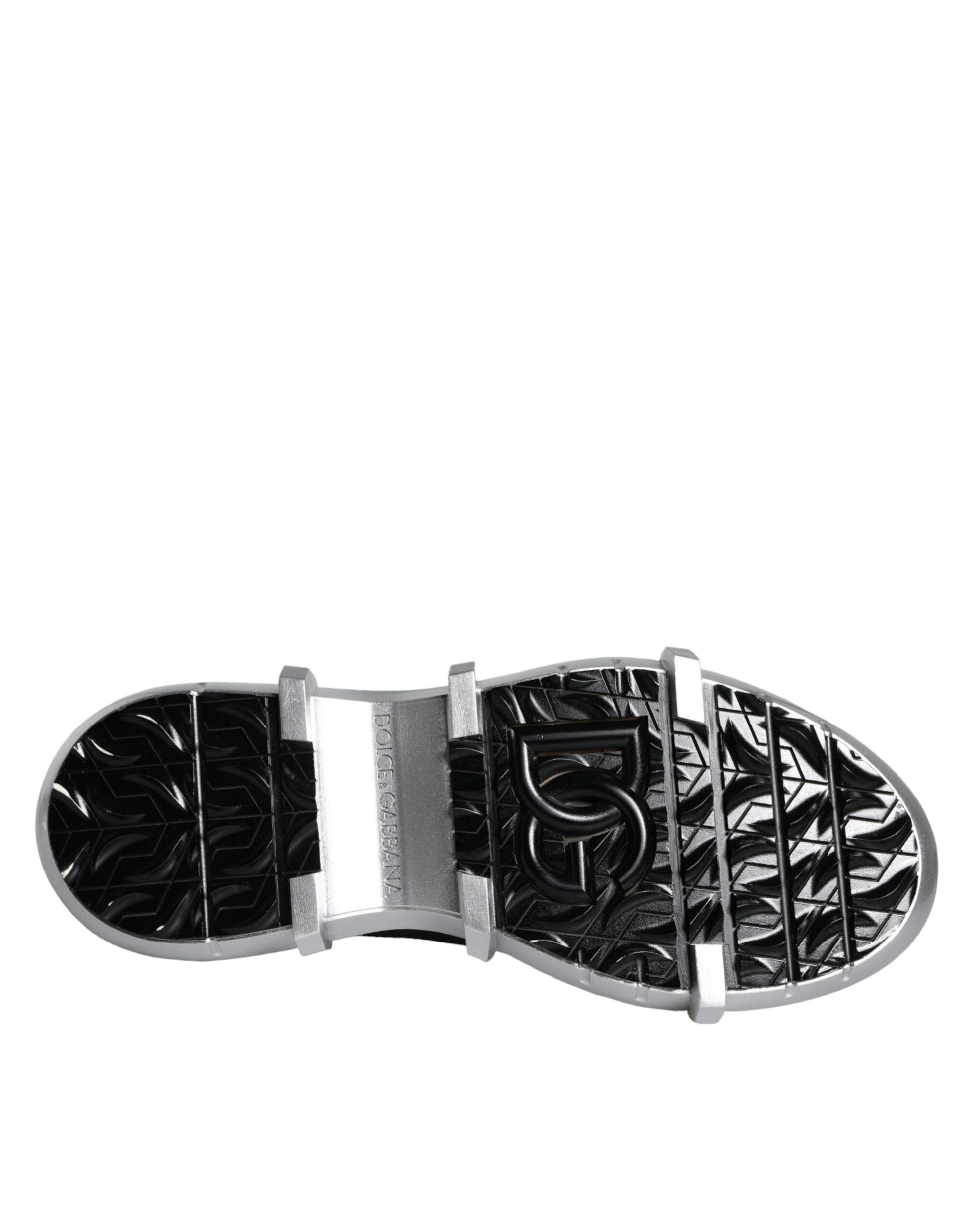 Black and white shoe with cleats on bottom