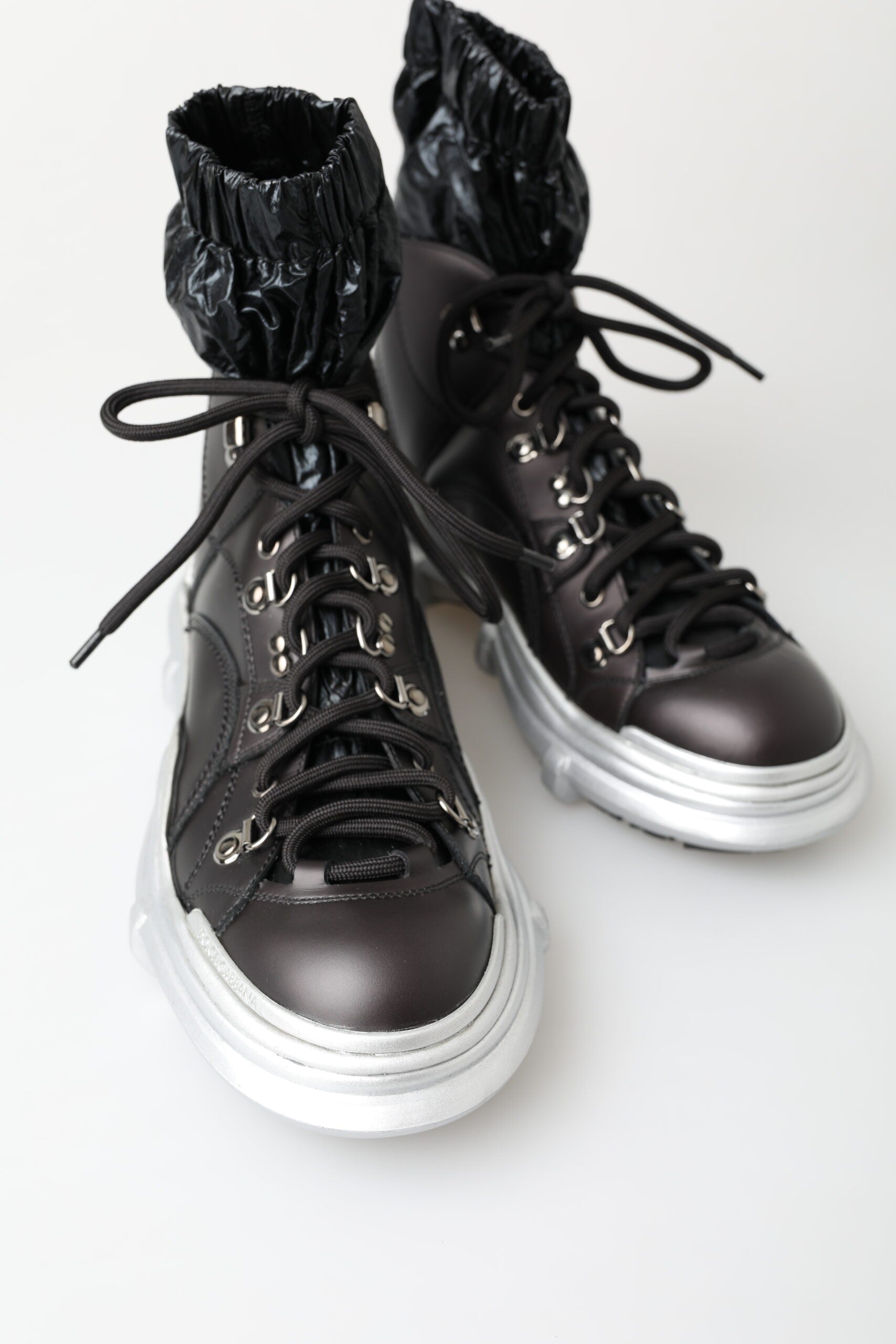 Pair of black boots with silver laces and buckles