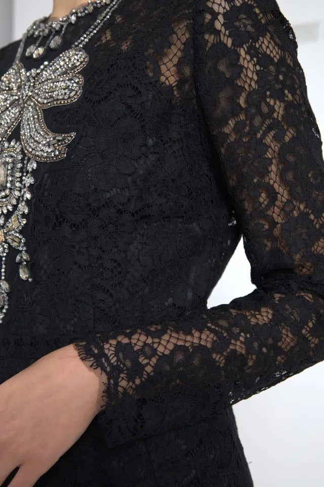 A black nylon lace embellished sheath dress with a fitted bodice and long sleeves