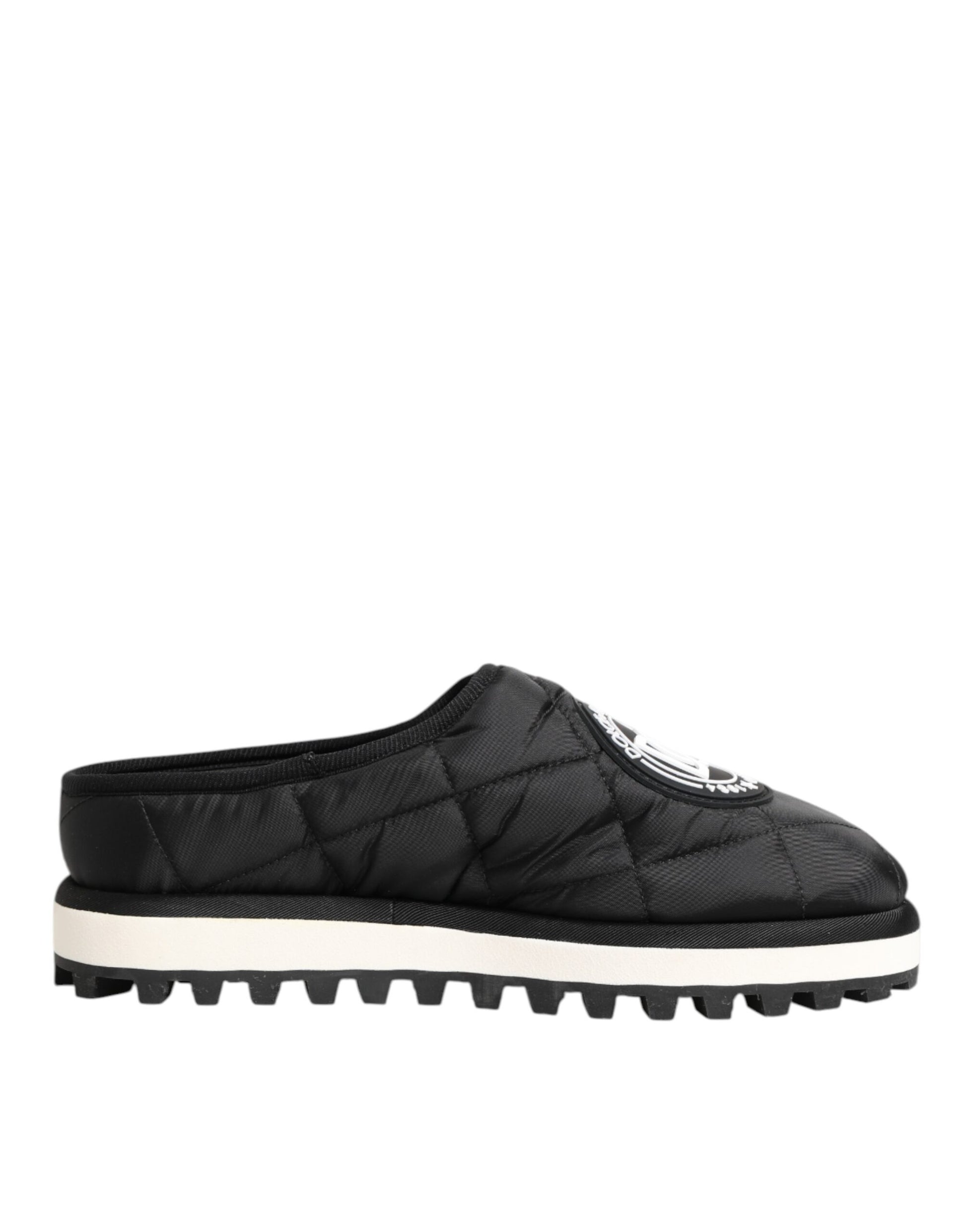 A pair of black nylon slip-on shoes with white soles