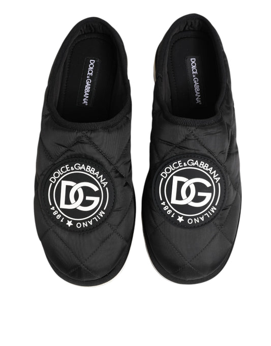 Pair of black nylon slip-on shoes with white logo on side