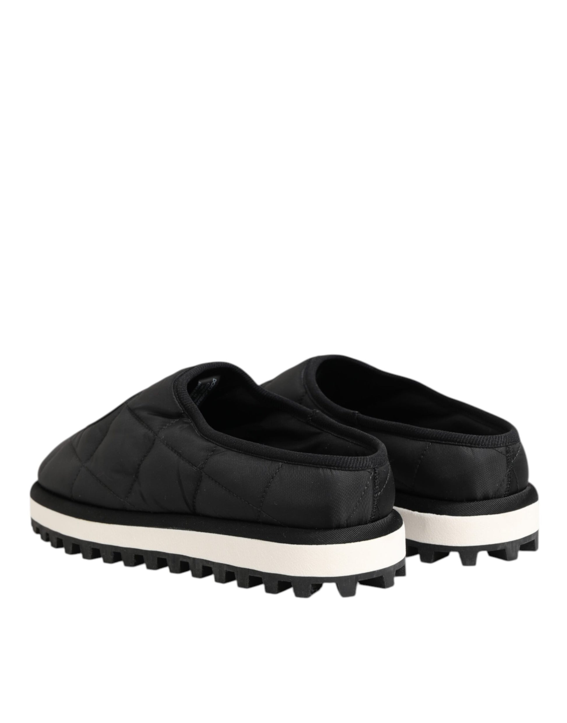 Pair of black nylon slip-on shoes with white sole, featuring a quilted design