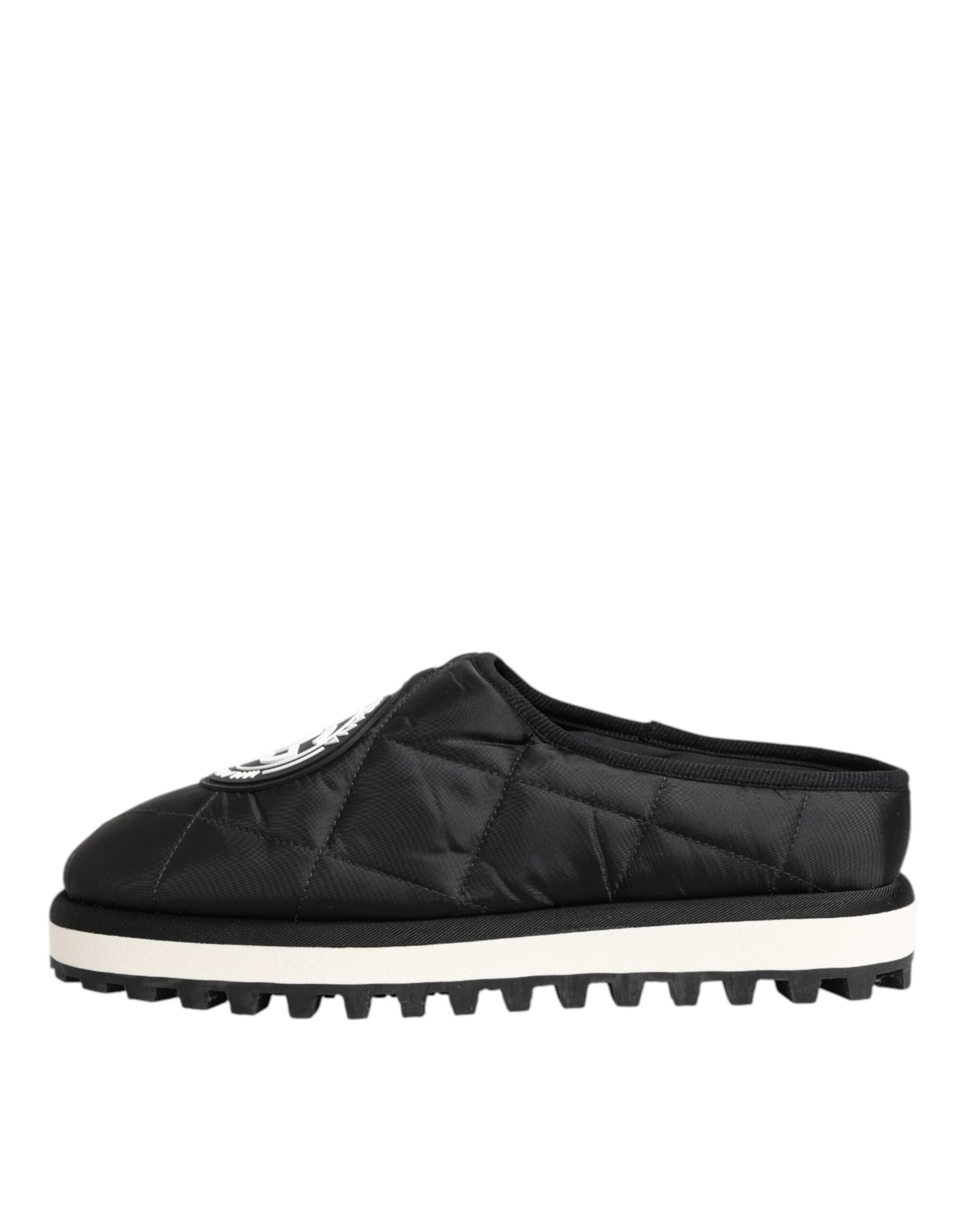 A pair of black nylon slip-on shoes with white soles