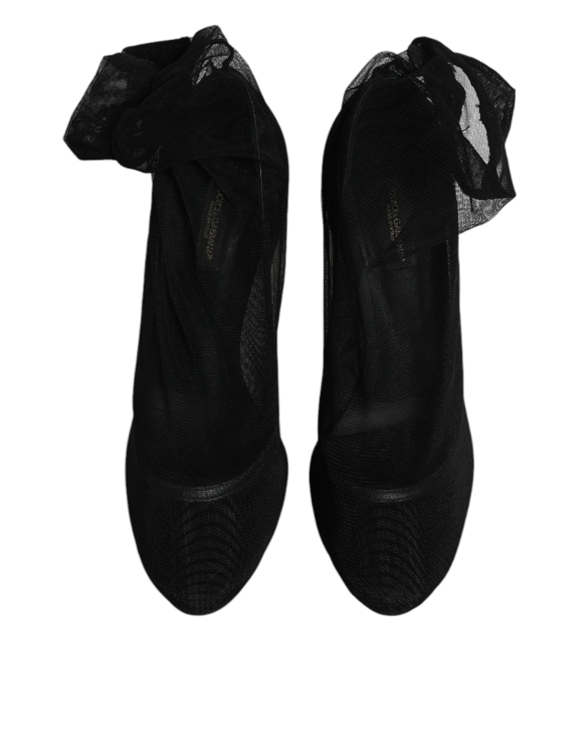 Pair of black high heel shoes with ruffled tops