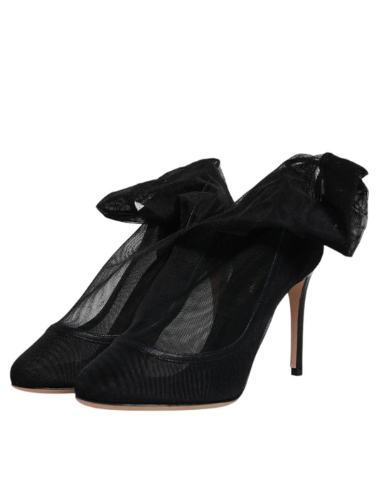High heel shoes with black straps and a bow on top