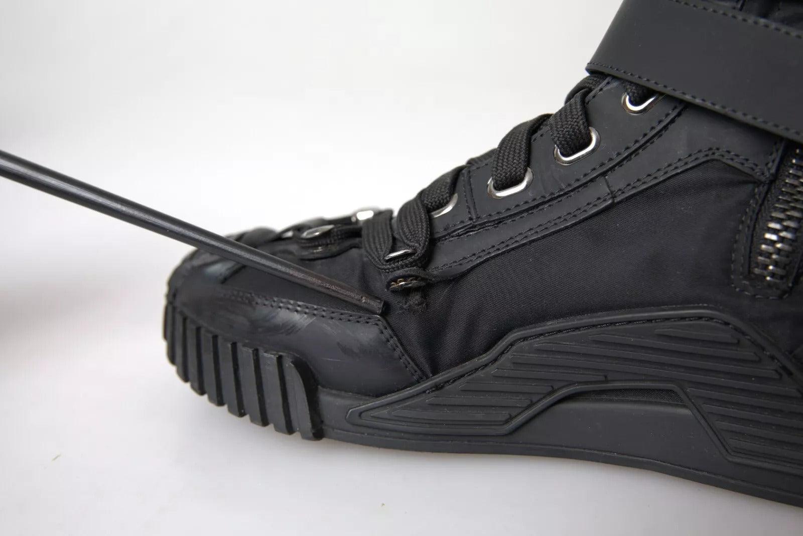 Black hiking boot with laces and metal eyelets