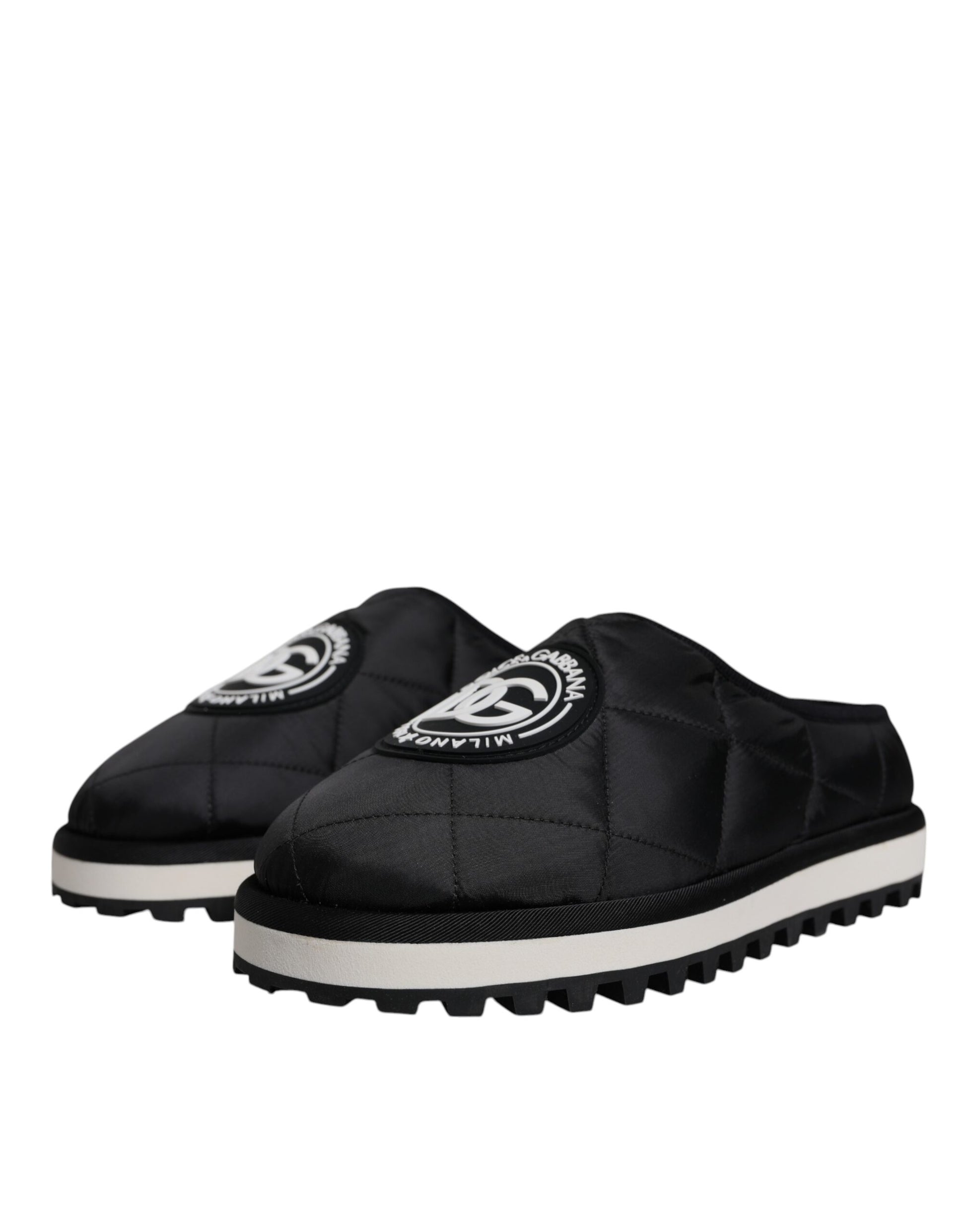 Pair of black slippers with white soles