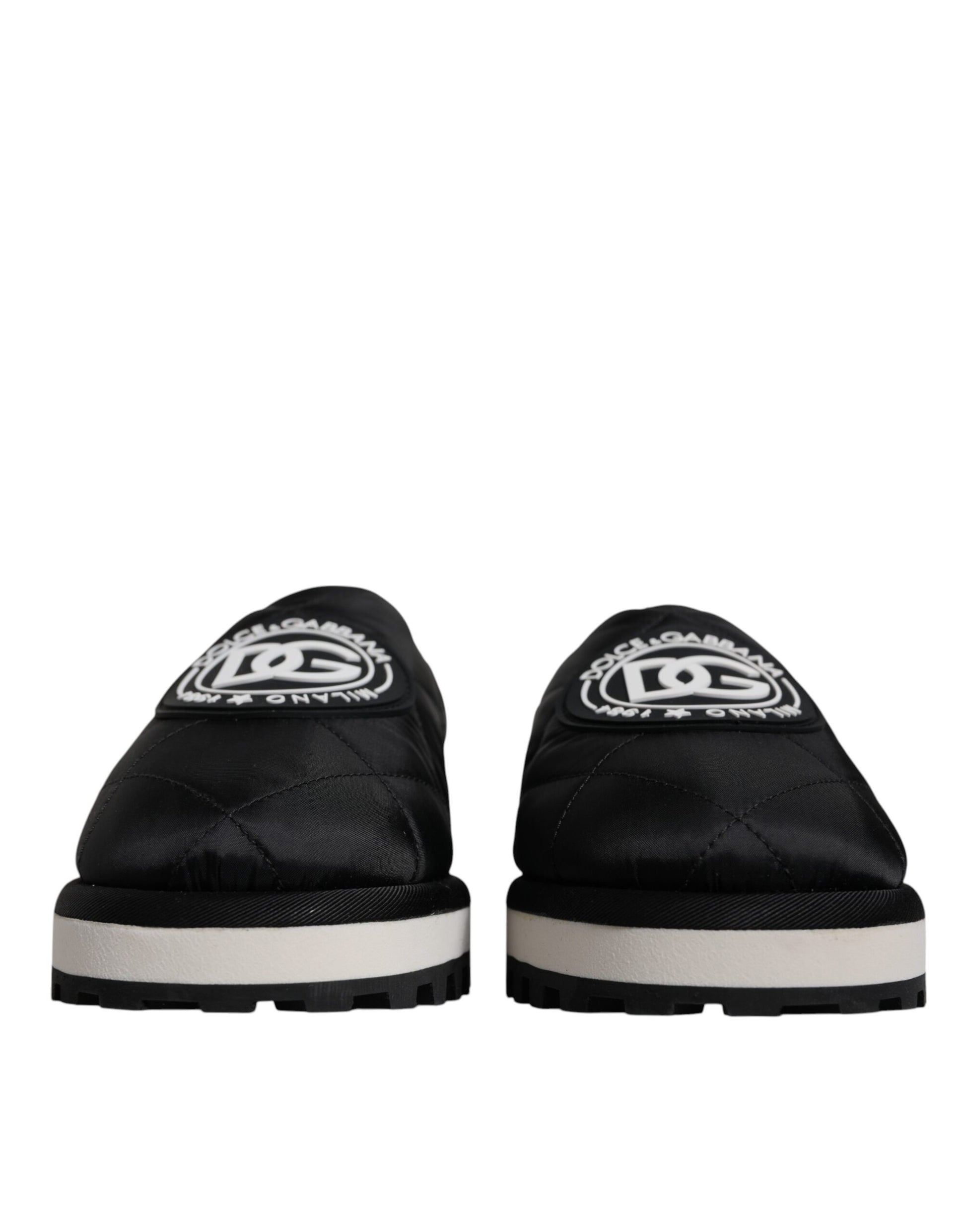 Pair of black slip on shoes with white sole