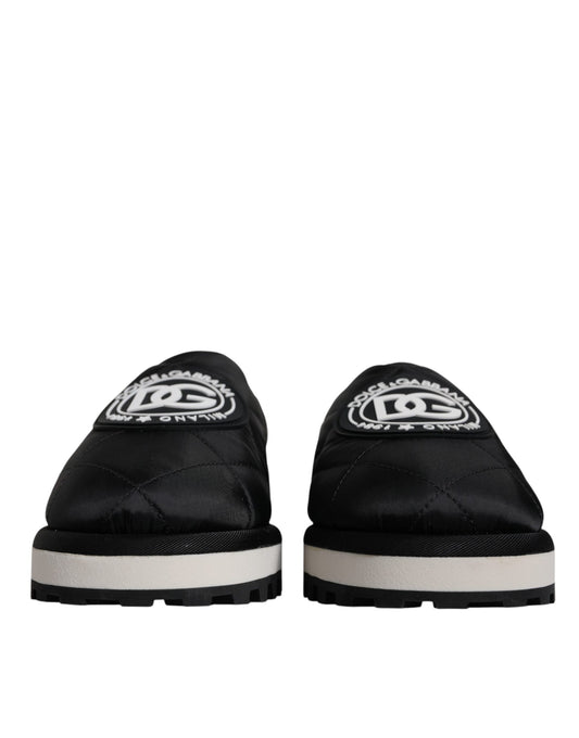 Pair of black slip on shoes with white sole