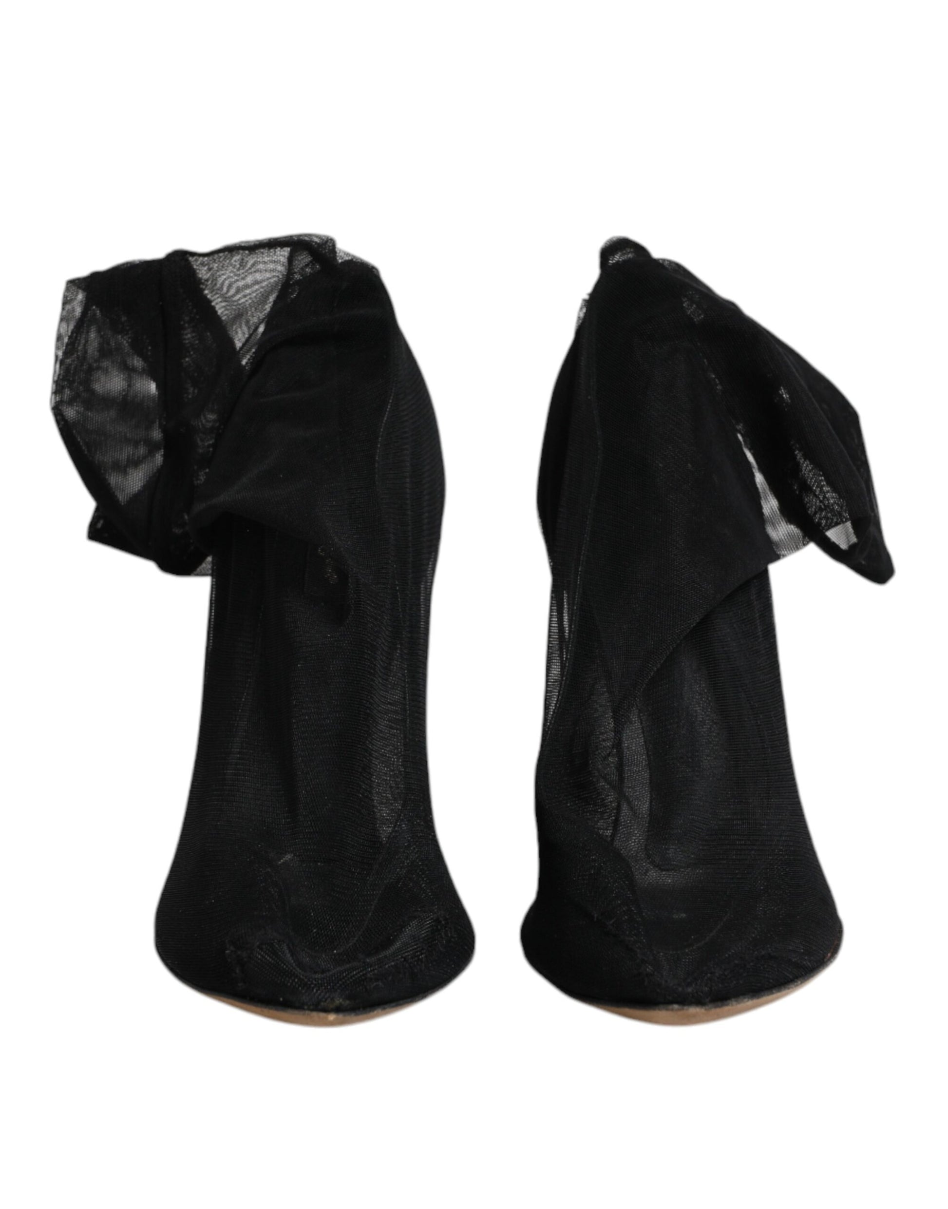 Pair of black high heel shoes with ruffled edges