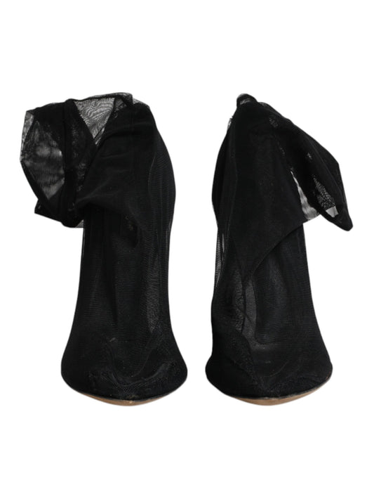 Pair of black high heel shoes with ruffled edges