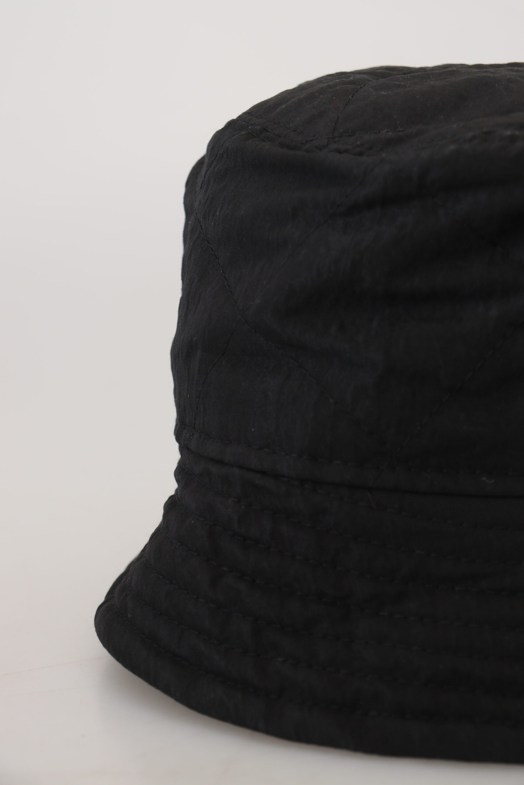 Black knit hat on white surface