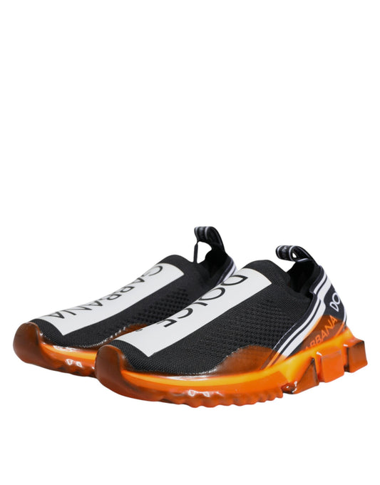 Pair of black and white sneakers with orange accents