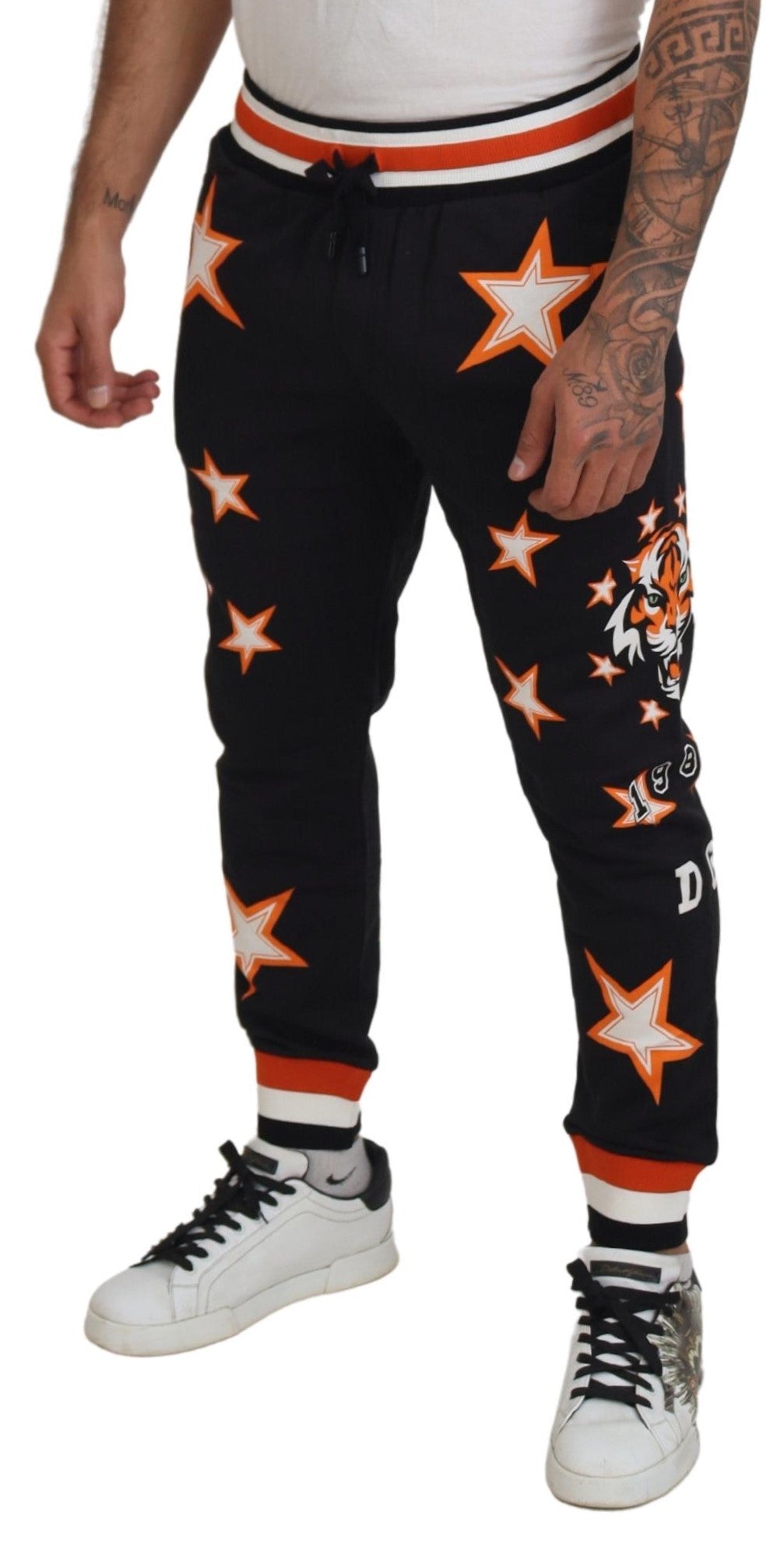 Man wearing black pants with white stars and stripes