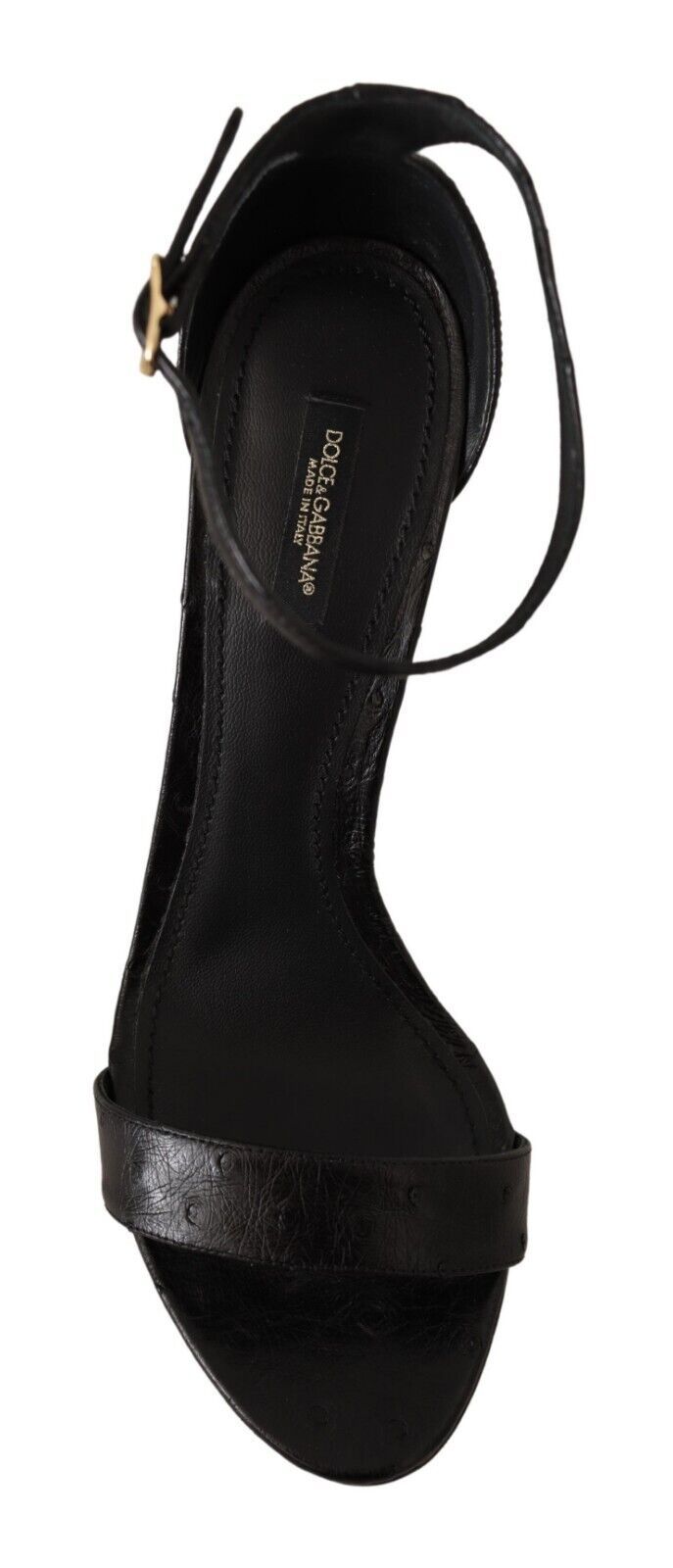Black high heel shoe with ankle strap and gold buckle