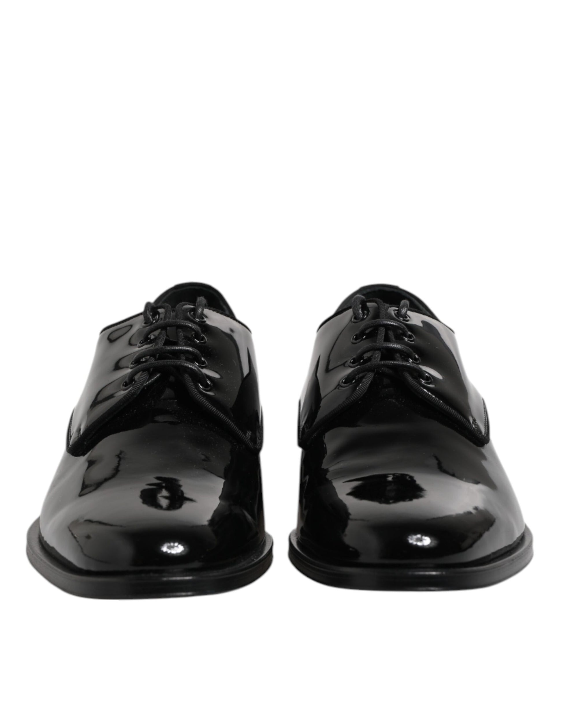 Pair of black patent leather dress shoes with laces and a small round emblem on the side