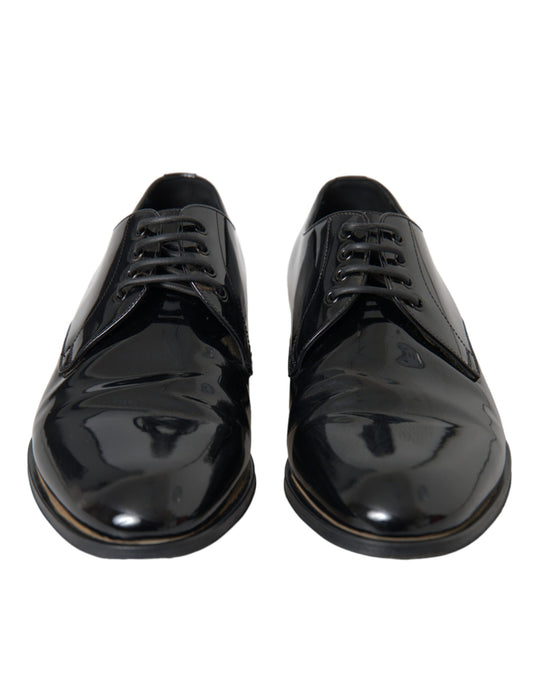 Pair of black patent leather dress shoes with laces and a shiny finish