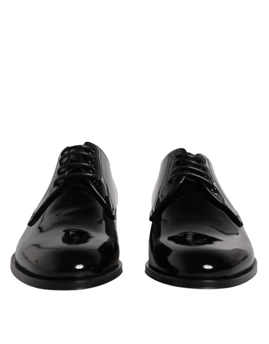 Pair of black patent leather dress shoes with laces and a shiny finish