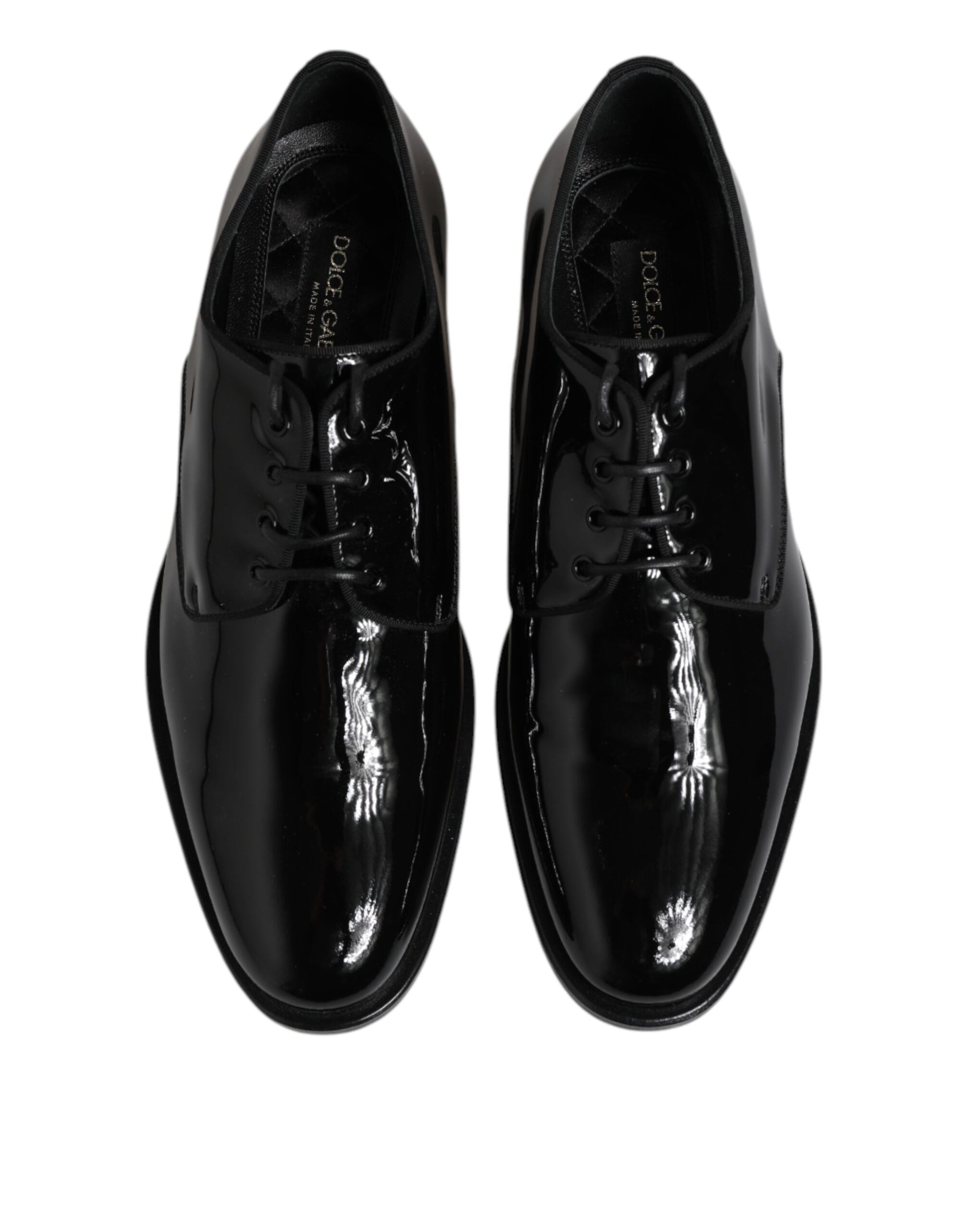 Pair of black patent leather dress shoes with laces and a shiny finish