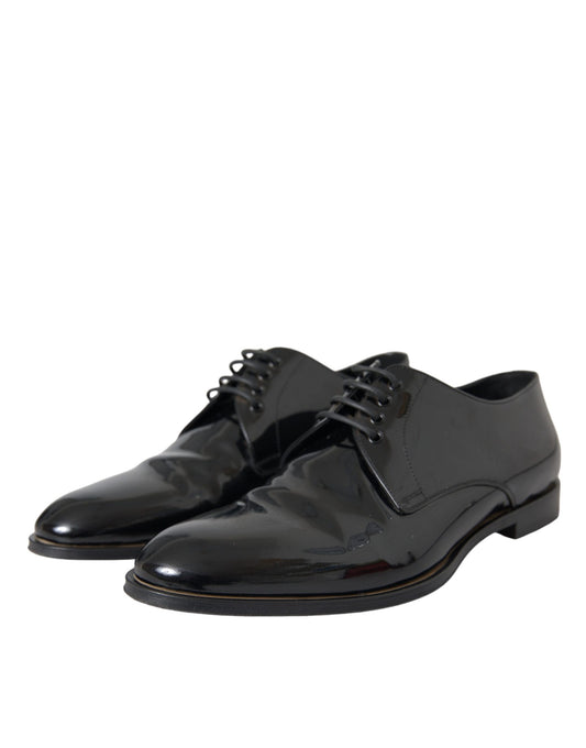 Pair of black patent leather dress shoes with laces and a small heel