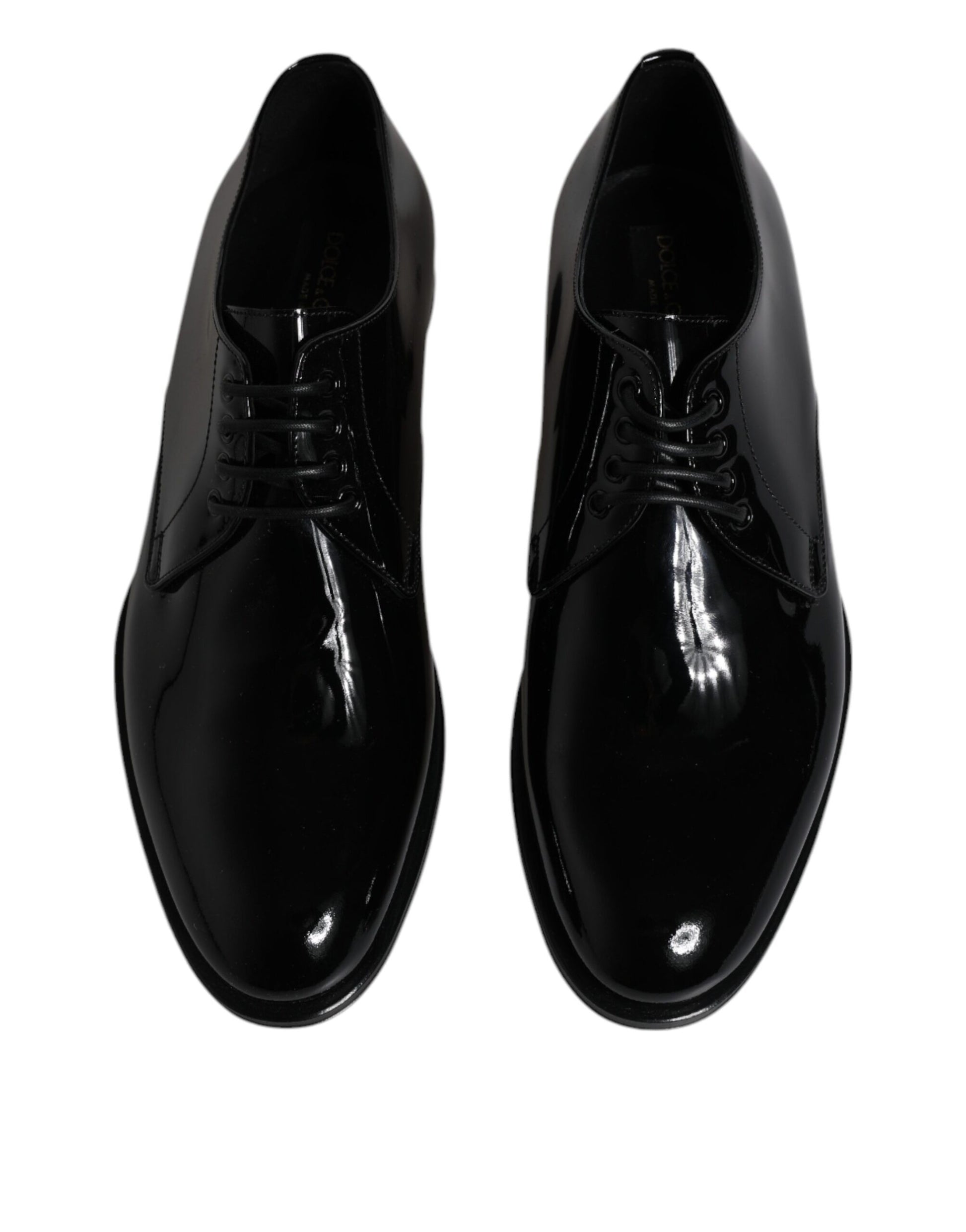 Pair of black patent leather dress shoes with laces and a small bow on the front