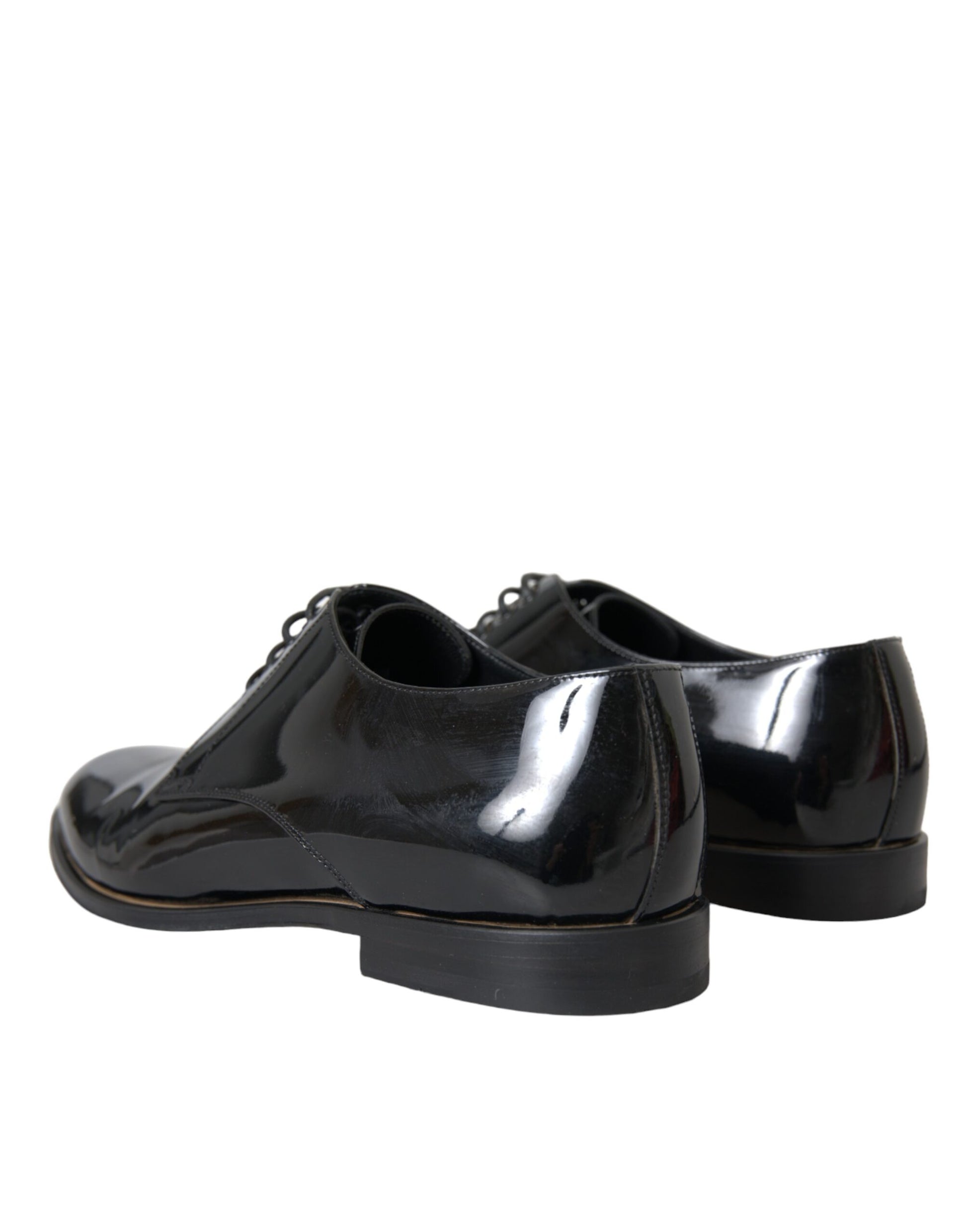 Pair of black patent leather dress shoes with laces and a low heel