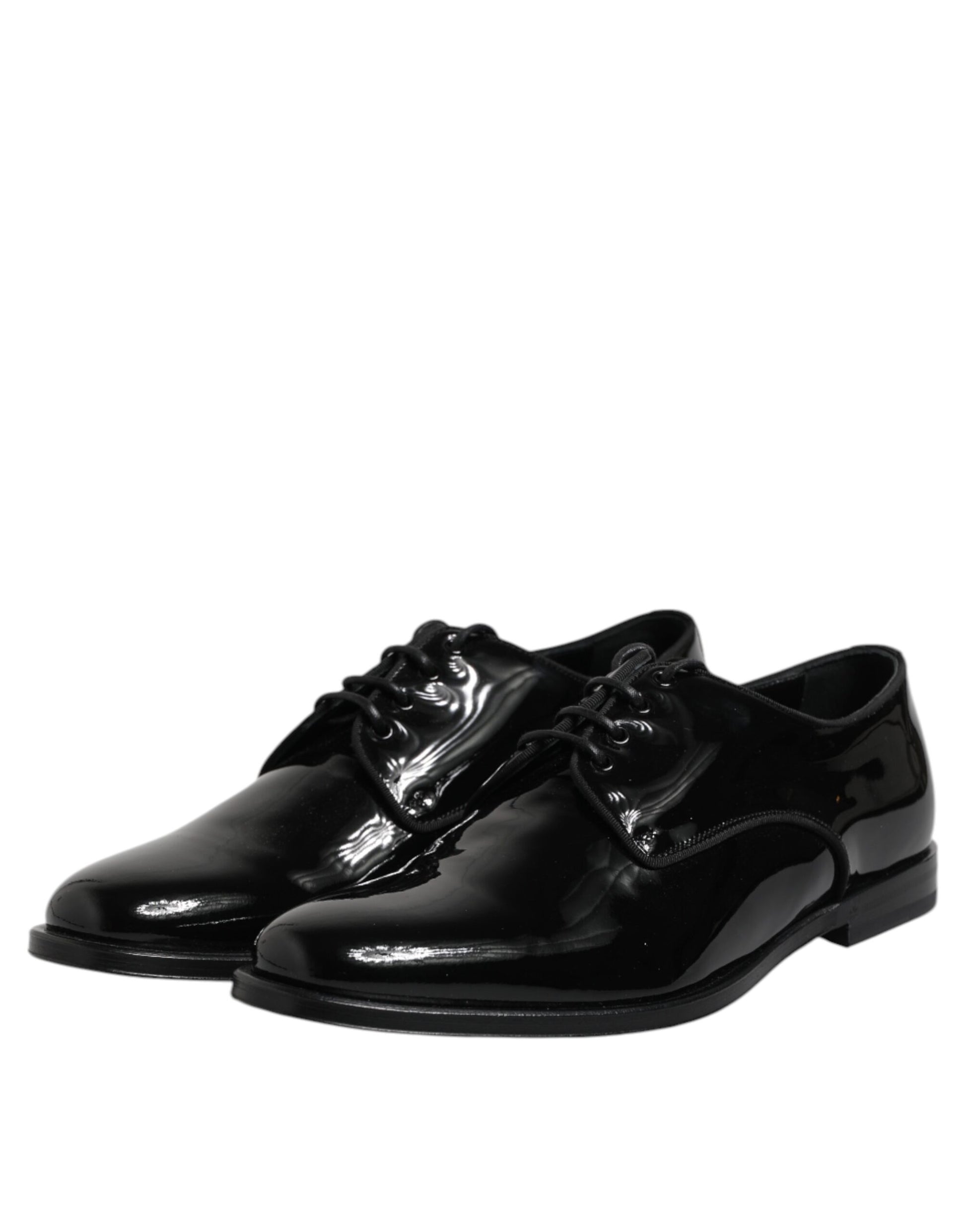 Pair of black patent leather dress shoes with laces and a bow tie design