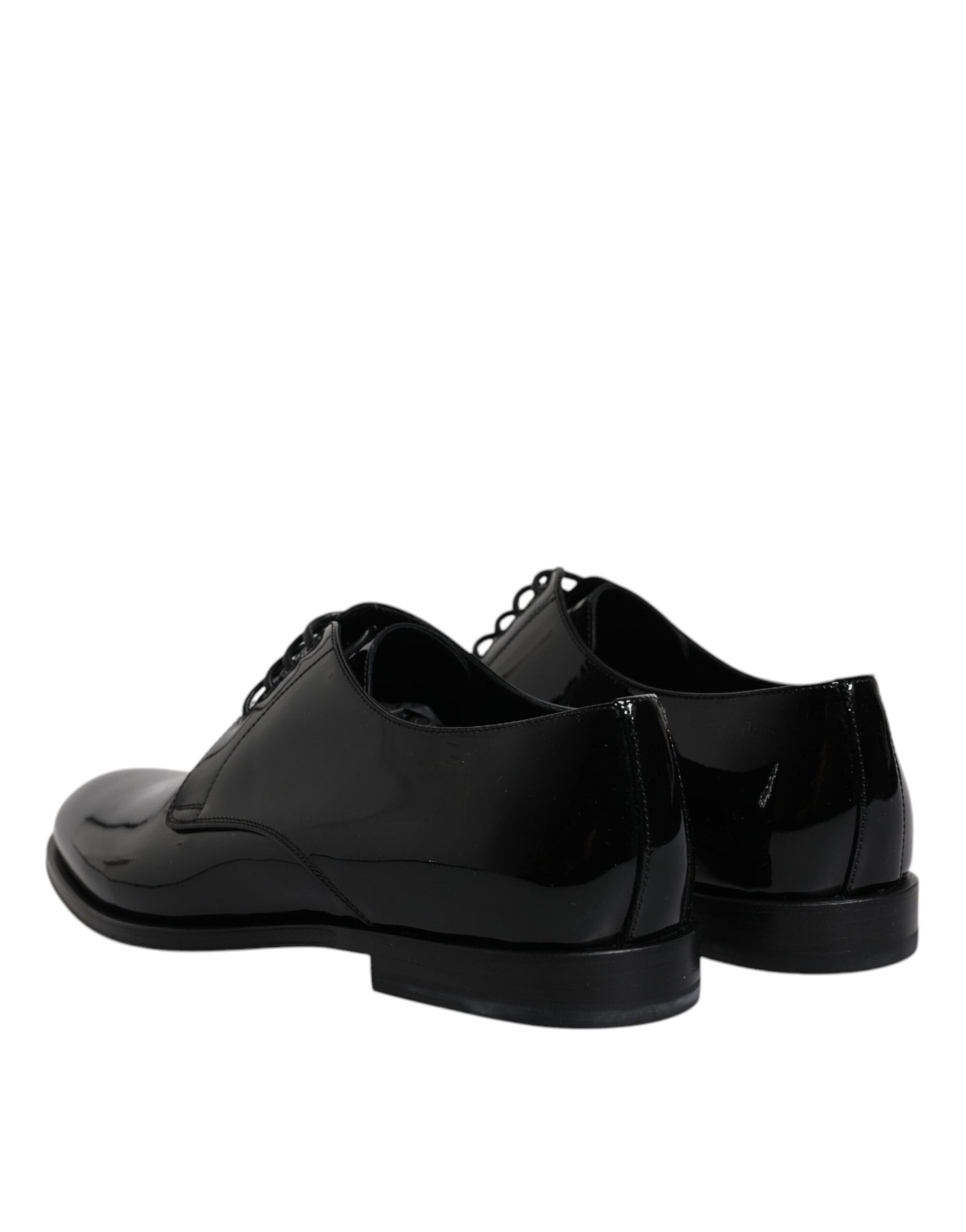 Pair of black patent leather dress shoes with laces and a low heel
