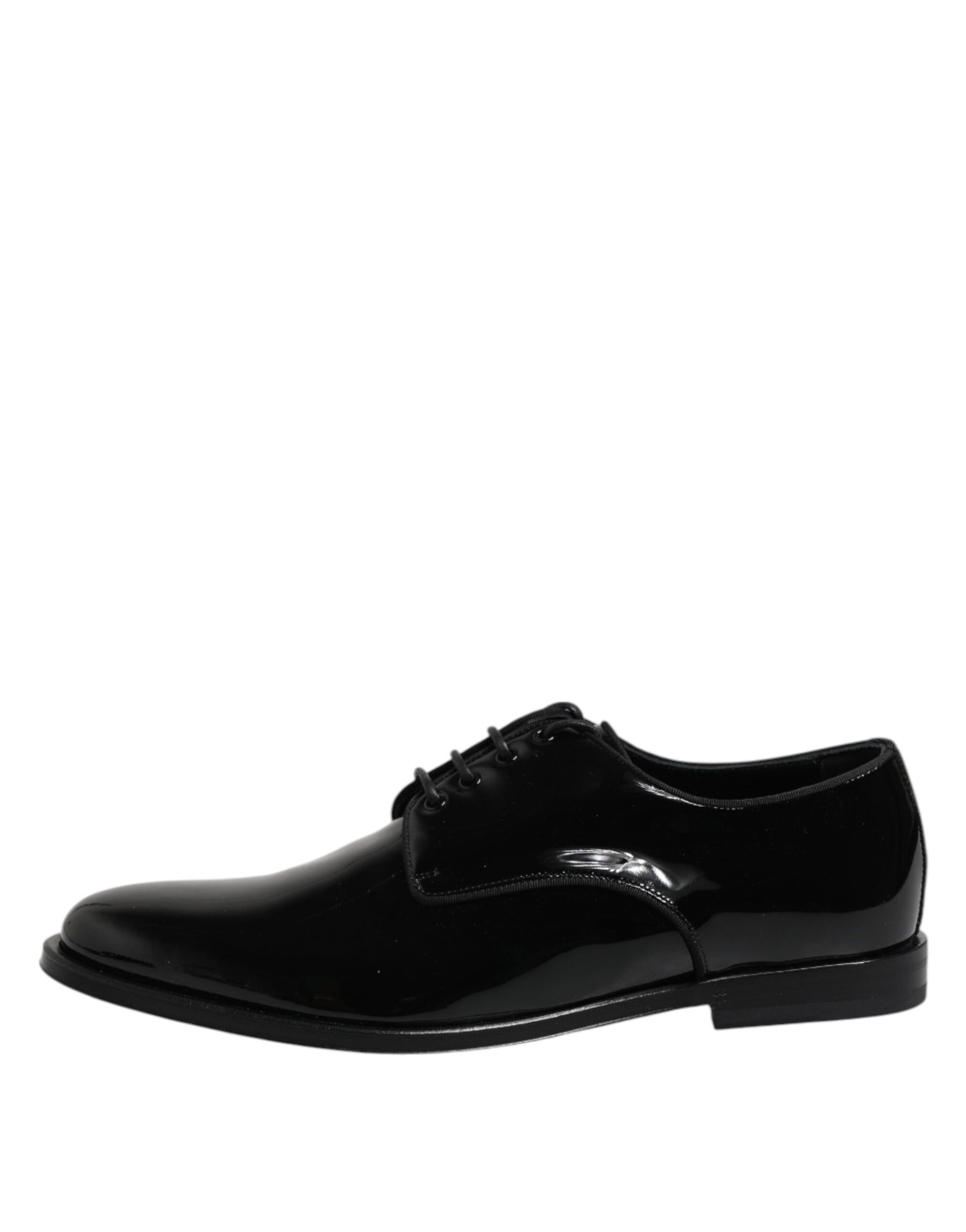 A pair of black patent leather dress shoes with a bow tie design on the front