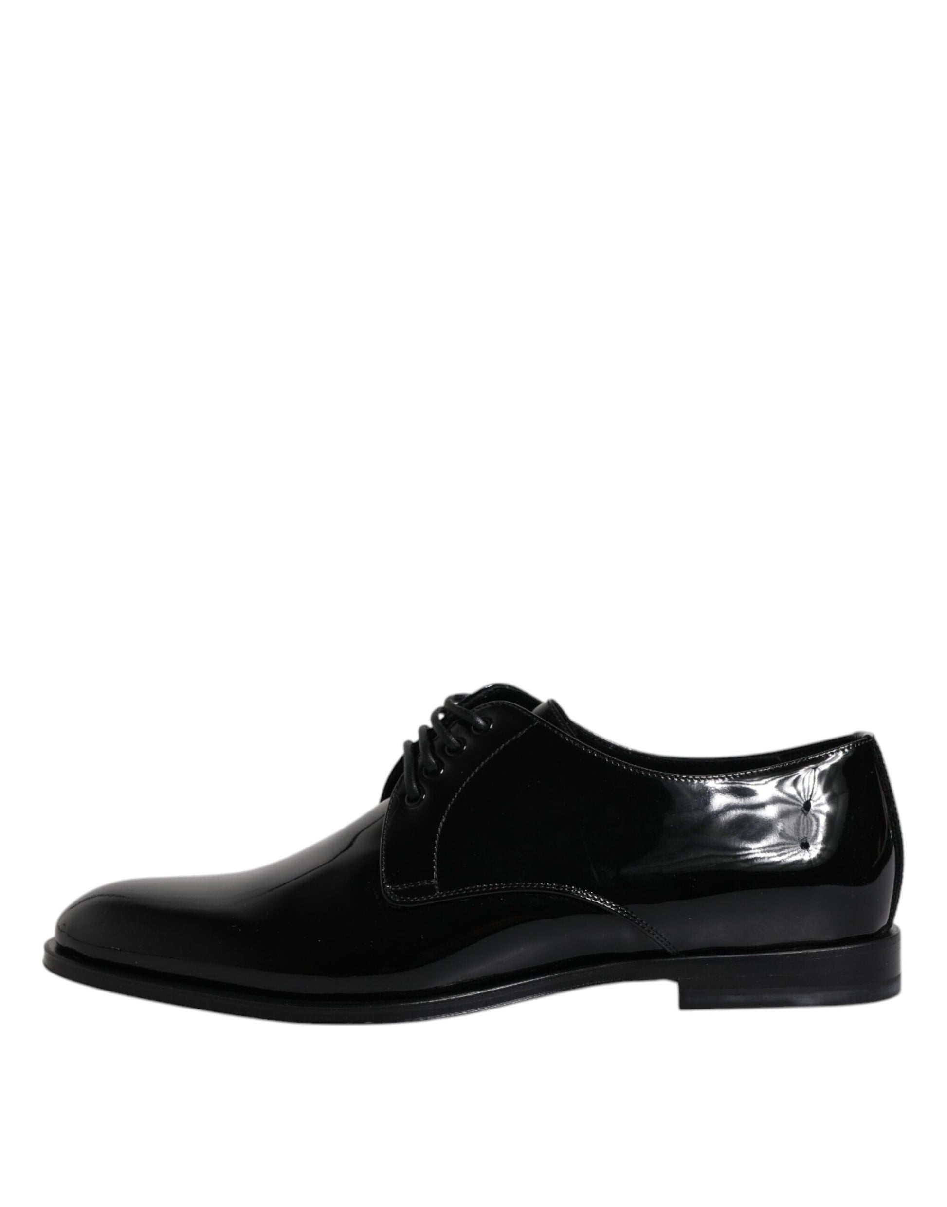 A pair of black patent leather dress shoes with a bow tie design on the toe