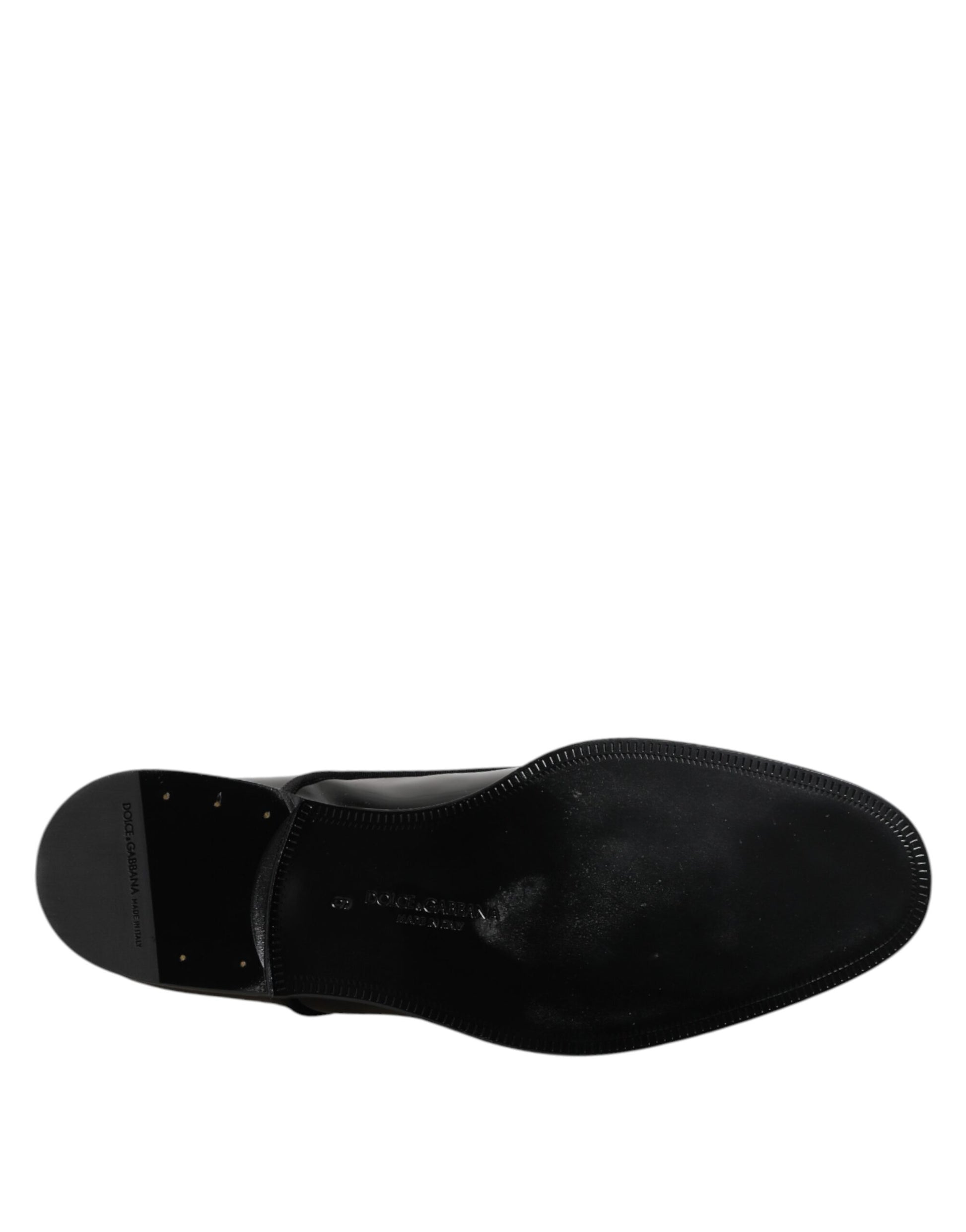 Pair of black patent leather dress shoes with laces and a shiny finish