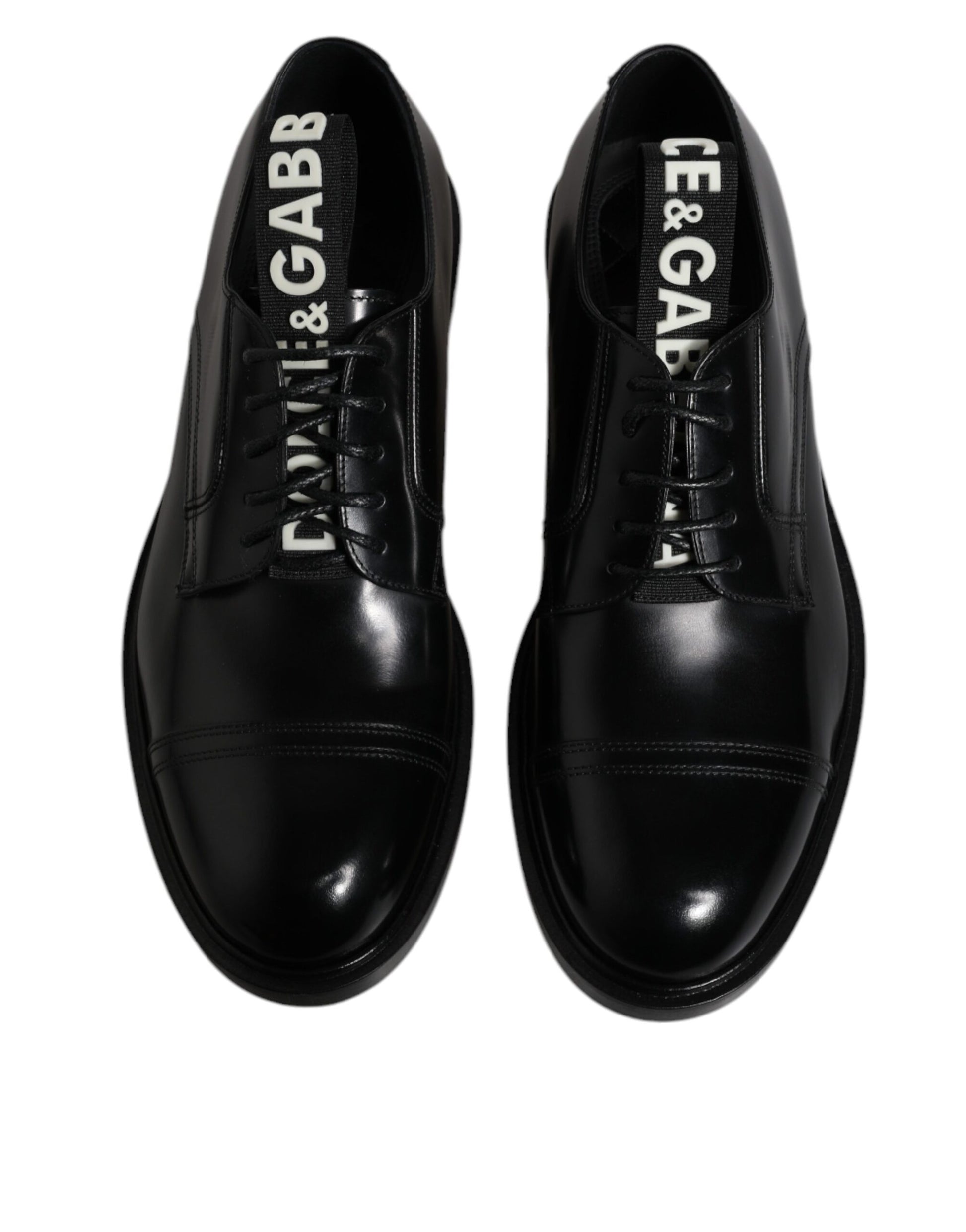 Pair of black patent leather dress shoes with laces, featuring the brand name "Dolce & Gabbana" on side