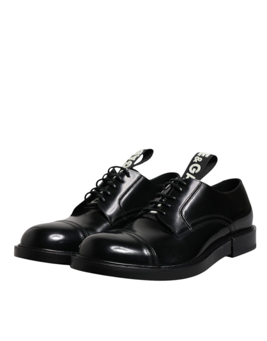 Pair of black patent leather dress shoes with laces, featuring a derby style and a shiny finish