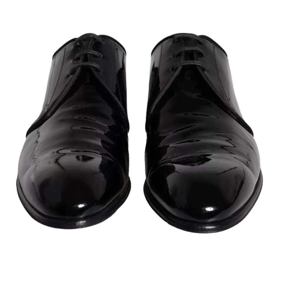 Pair of black patent leather dress shoes with laces