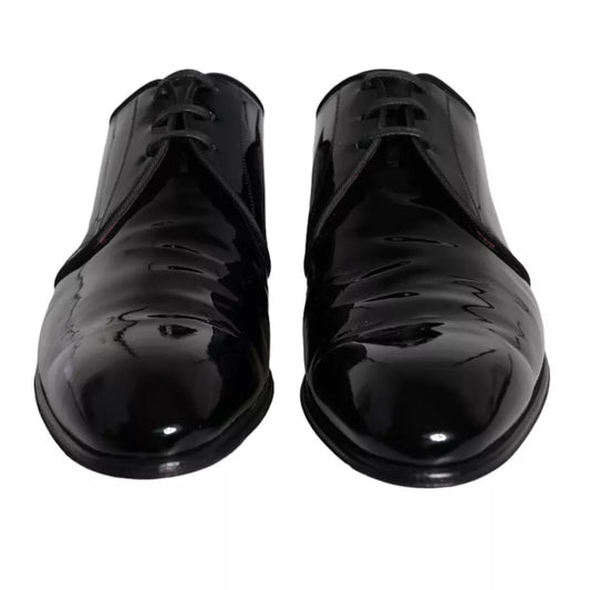 Pair of black patent leather dress shoes with laces