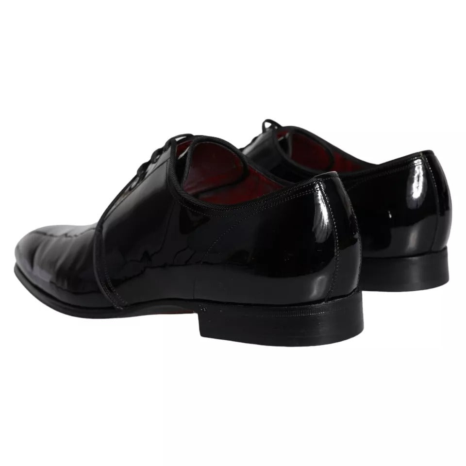 Pair of black patent leather dress shoes with laces and a shiny finish